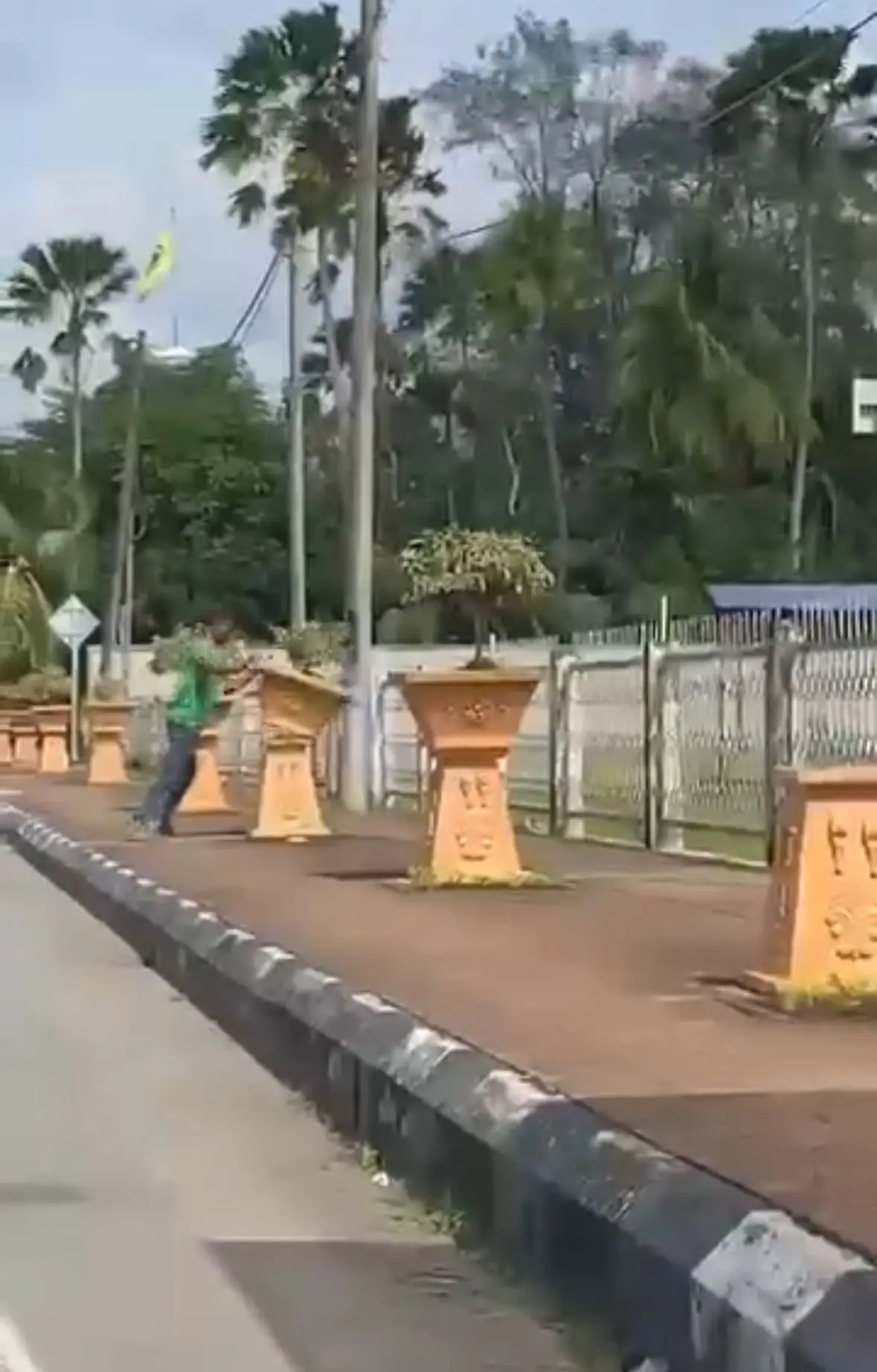 man smashes flower pots near police station