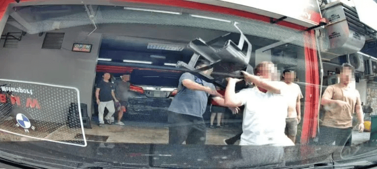 Man swings chair at car wash worker