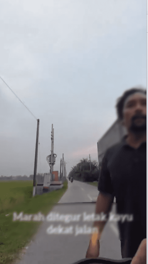 man trying to hit a motorcyclist