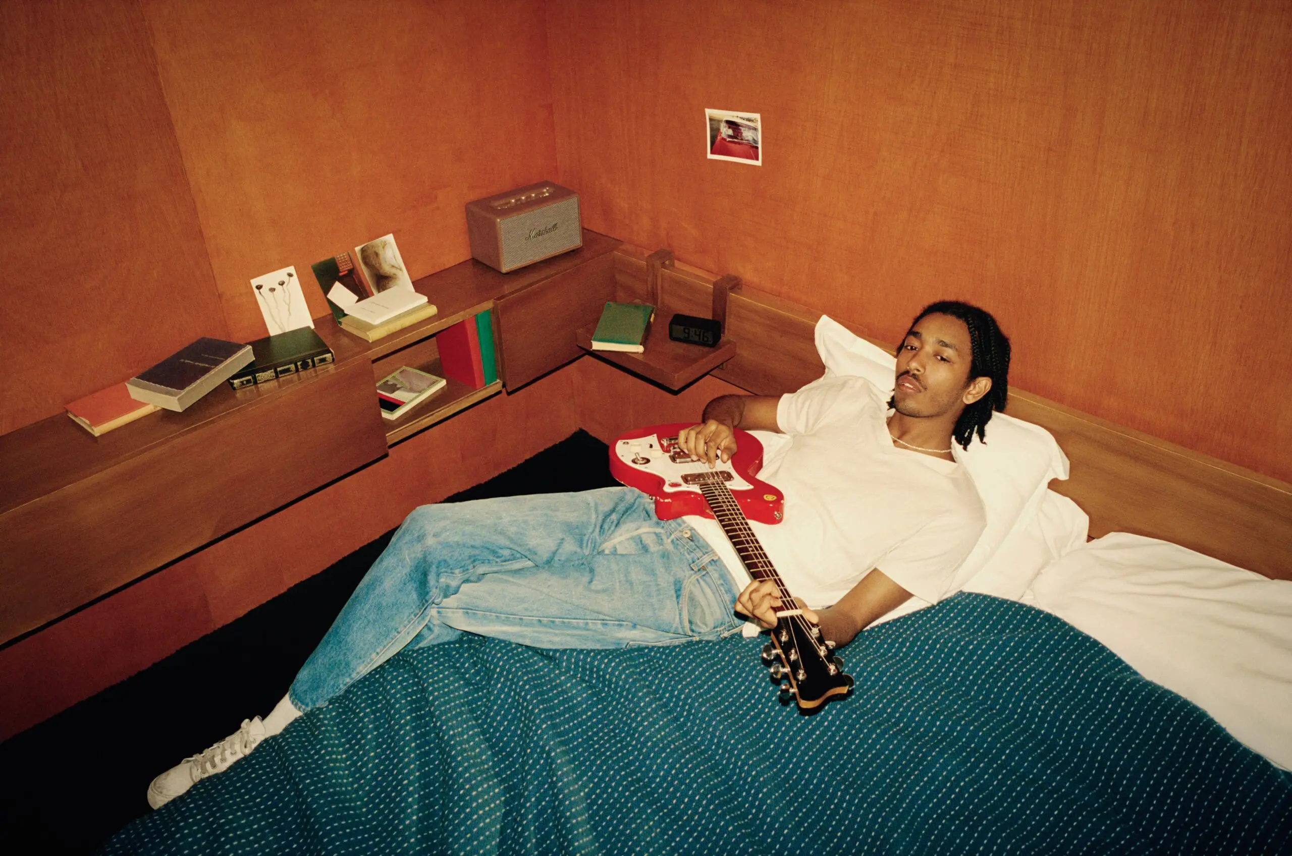 Man playing his guitar with Marshall Homeline III