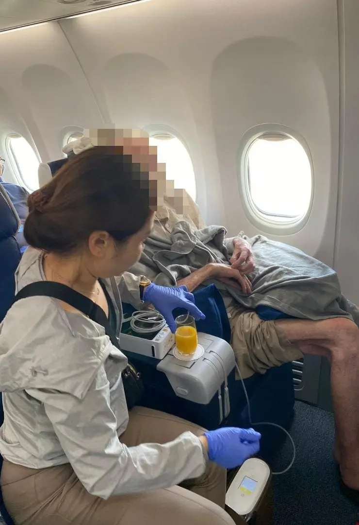 MAS cabin crew treating his patient on board