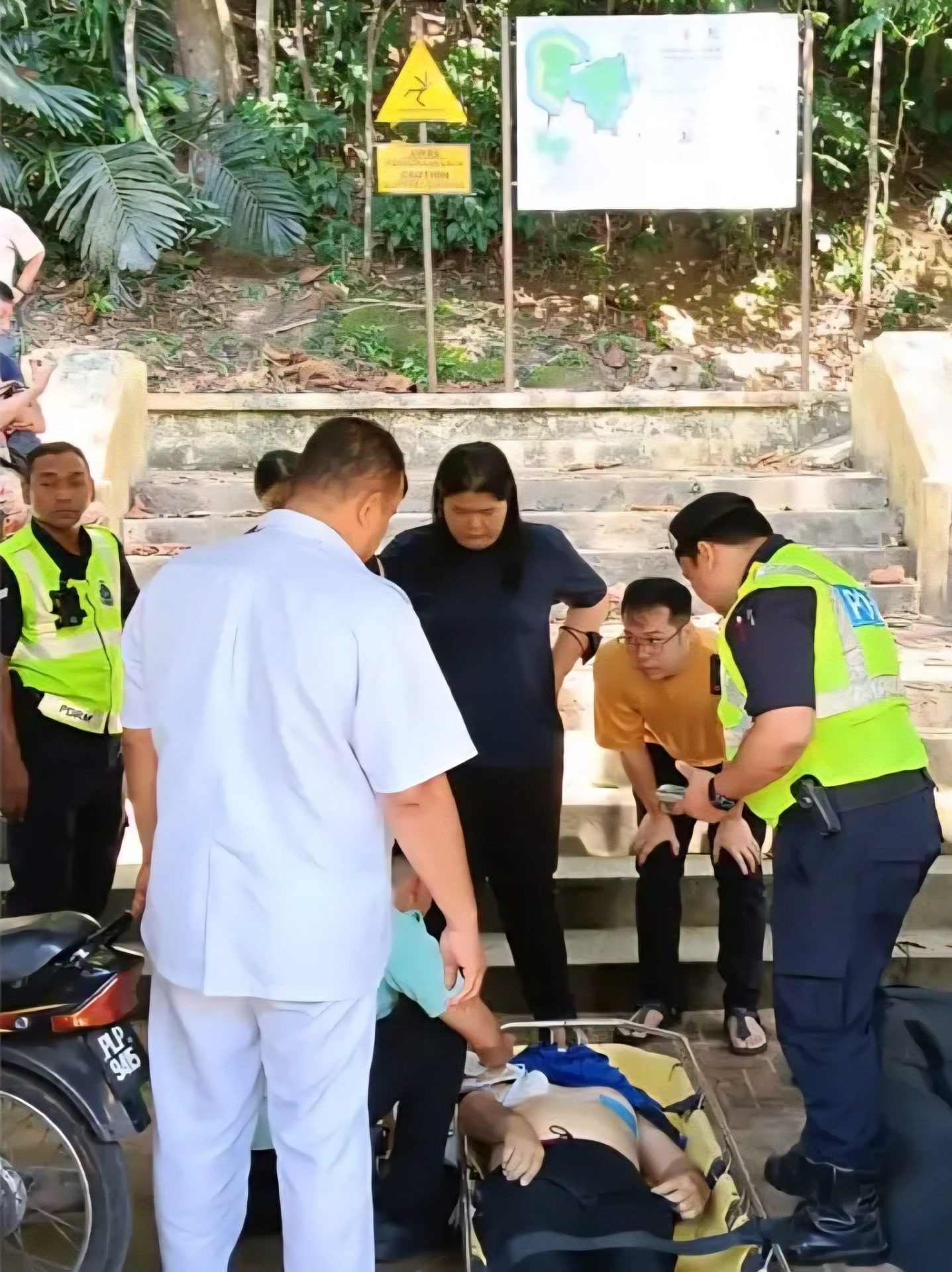 Medical personnel trying to revive man at the Botanic Gardens