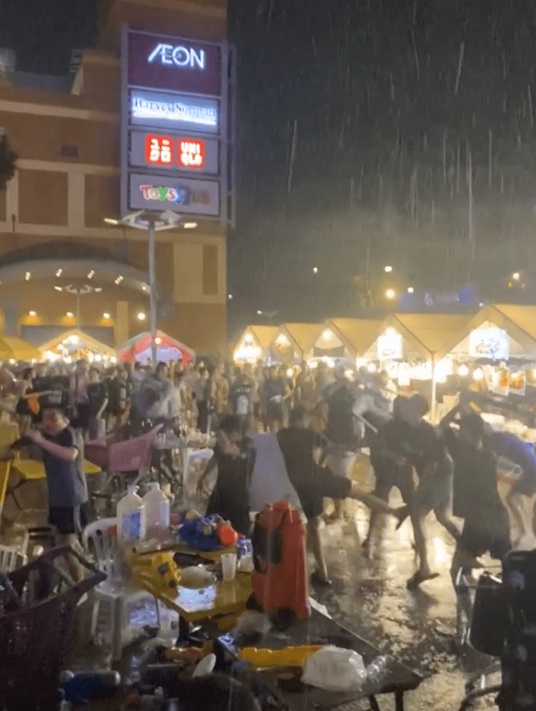 Men brawling in the rain at Songkran Festival