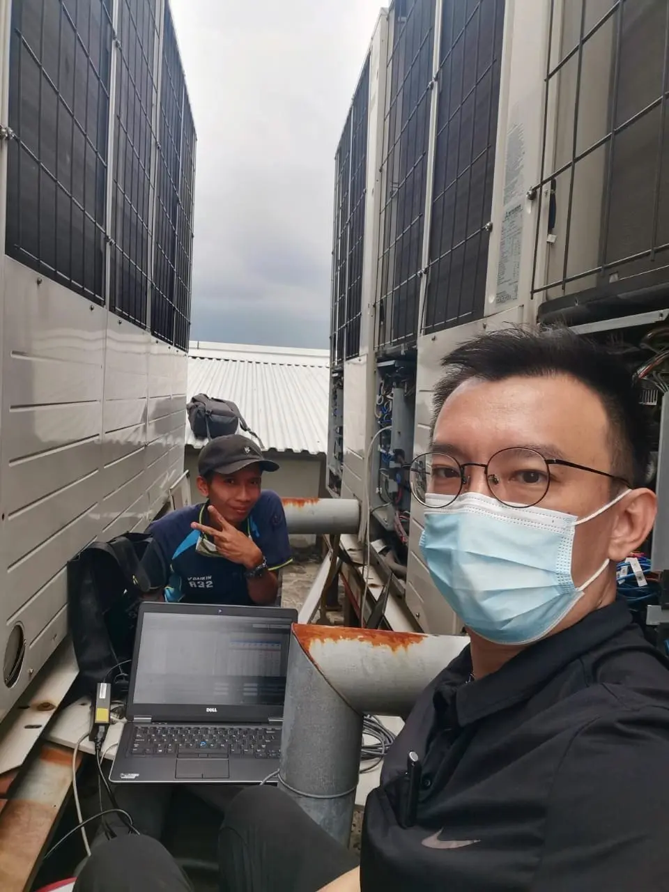 Danny and his employee fixing air cond