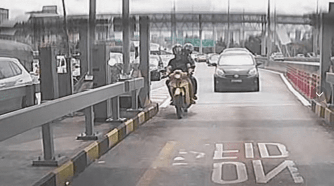 Motorcyclist tailgates car at toll gate