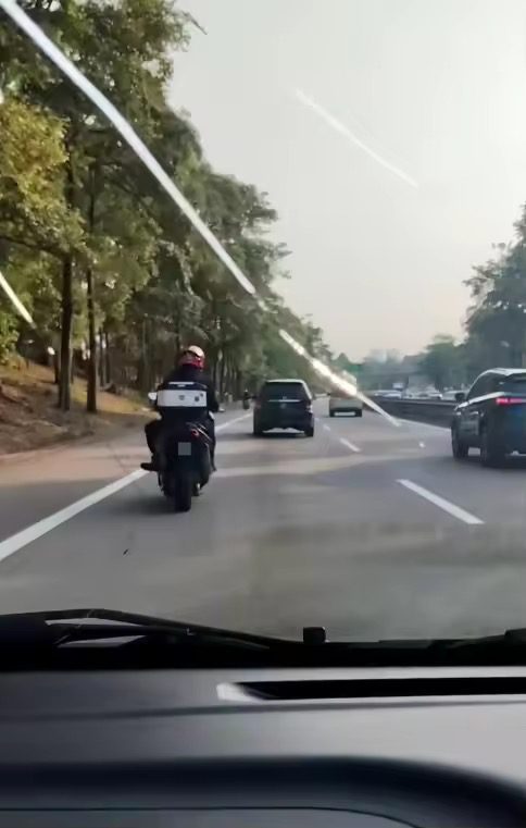 Motoryclist throws rock at car 1