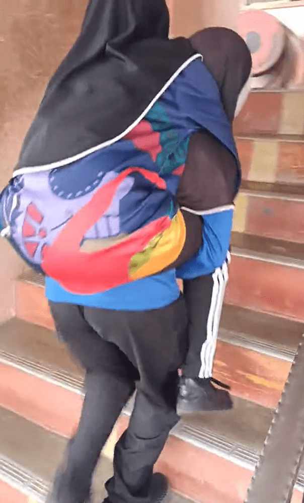 M'sian girl piggybacks OKU classmate up the stairs