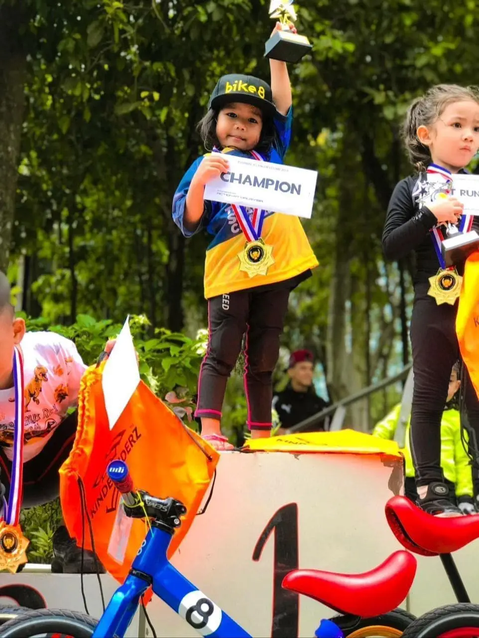 Msian girl receiving first place for push bike competition