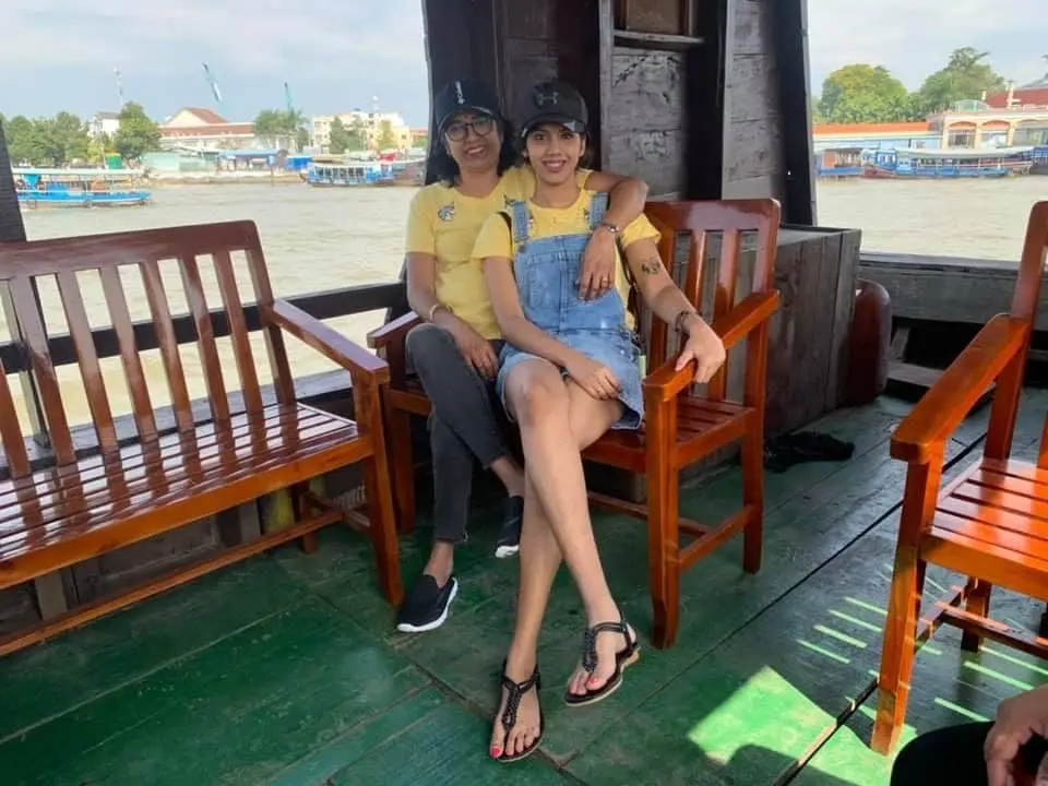 msian girl woth her mother on a moving boat