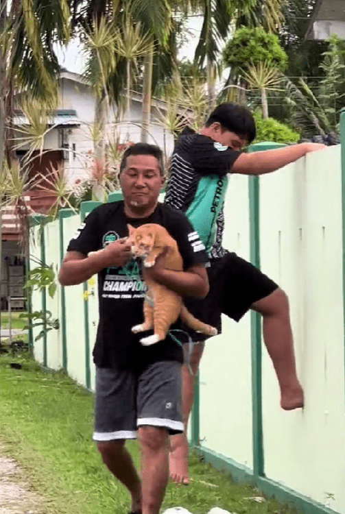 msian holding a cat