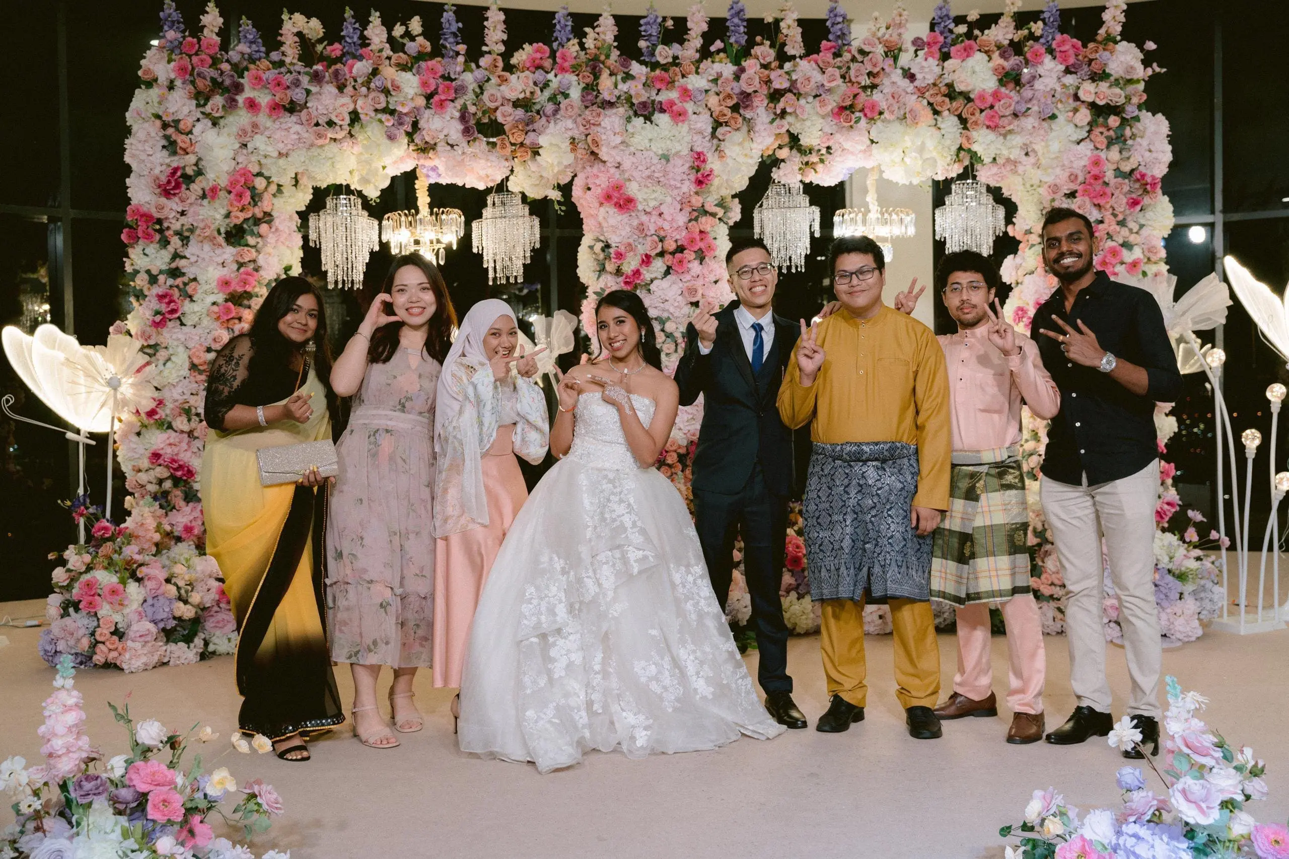 msian interracial couple with their friends at the wedding reception