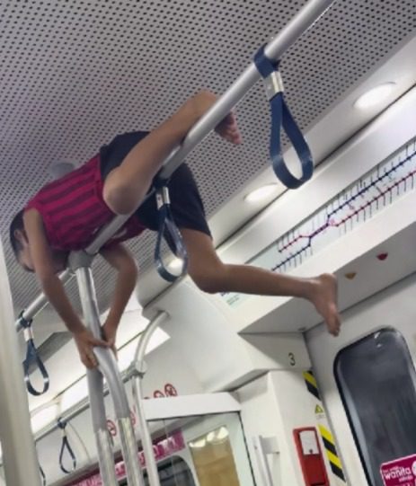 msian kis lying on top of pole at ktm