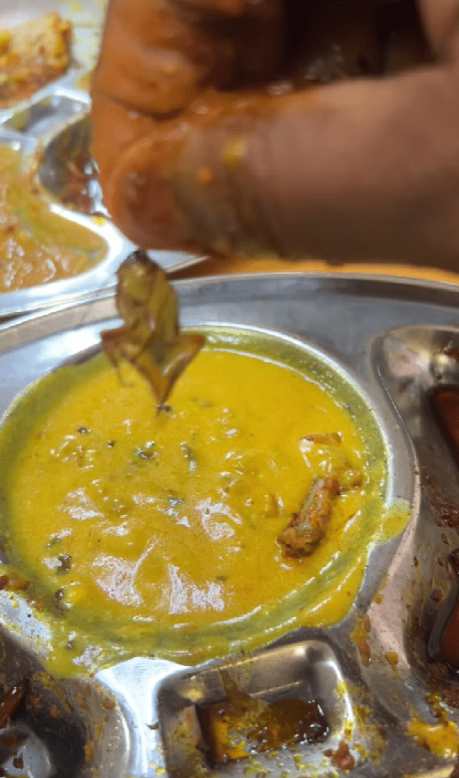 msian man showing dead cockroach he found in dhal curry in kl restaurant