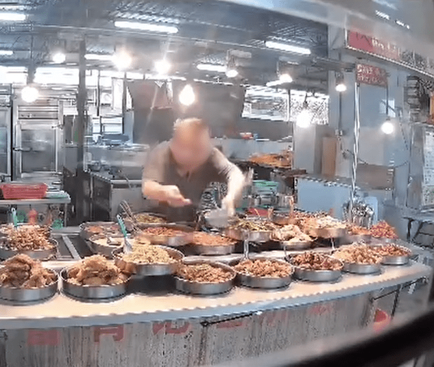 M'sian mixed rice stall owner uses same spoon to taste dishes