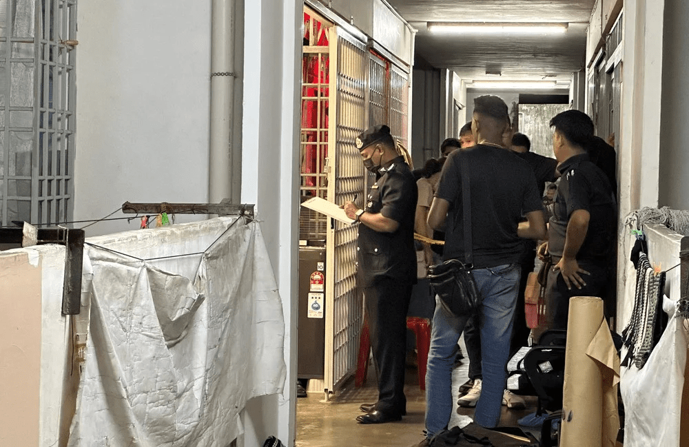 M'sian police at Relau apartment where woman was stabbed by her son