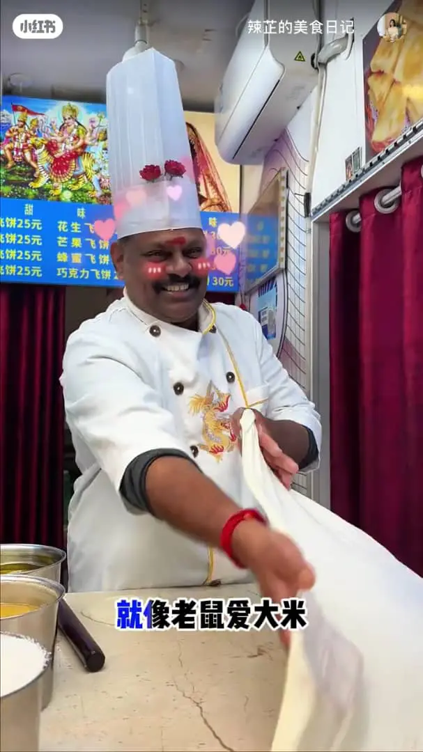 msian pulling the roti canai dough