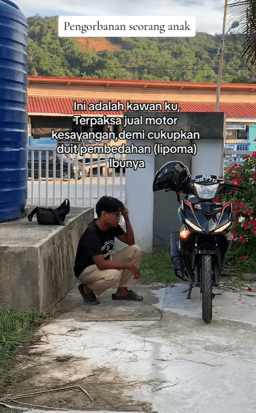 M'sian rider Naazrie Ali looks at motorbike