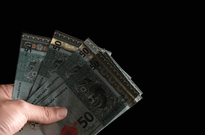 Hand holding Malaysian Ringgit