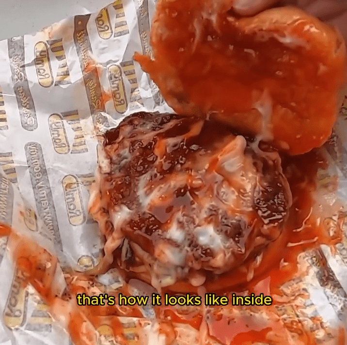 msian showing the burger that he purchased