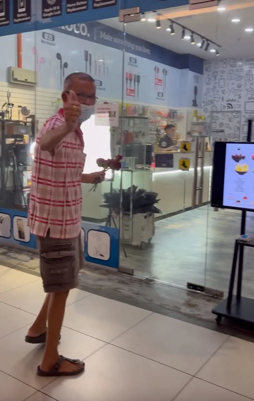 msian uncle entering cafe after gving out rose to stranger