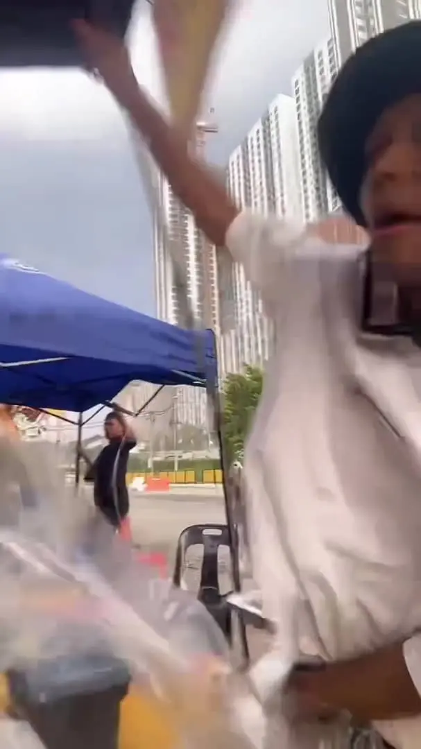 msian vendor holding his canopy