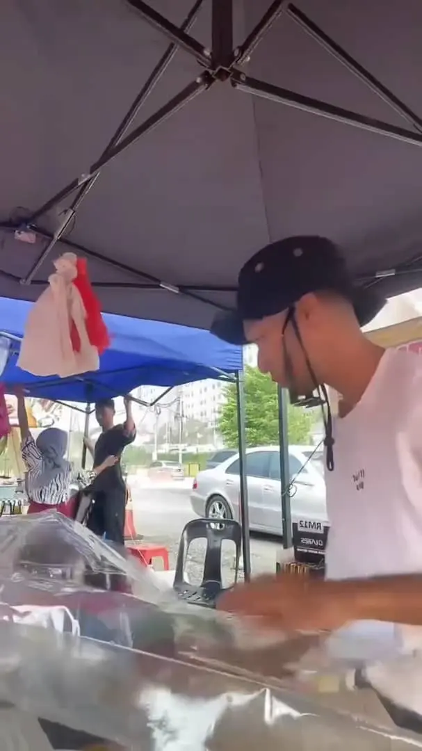 msian vendor setting up his canopy at ramadhan bazaar