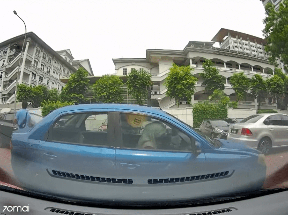 M'sian woman enters double parked Proton Waja