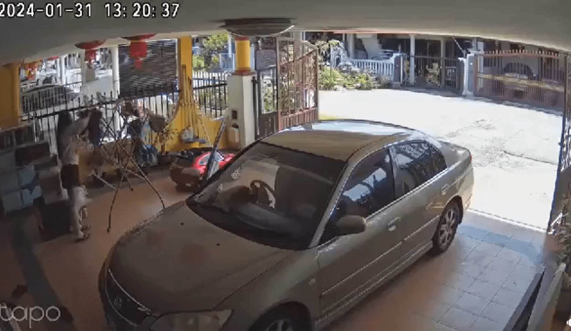 M'sian woman hangs clothes after coming back from the bank