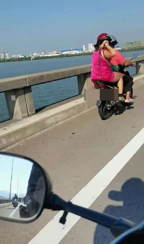 msian woman hitting riders with black rope