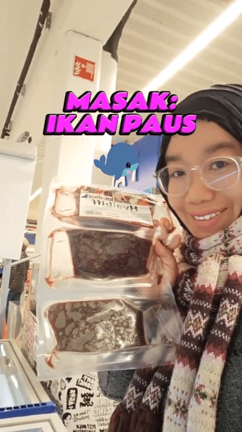 msian woman showing a pack of whale meat in a grocery meat