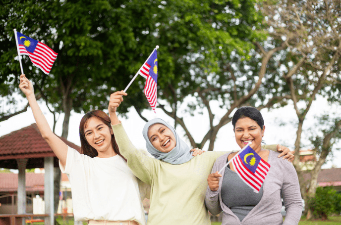 Group of M'sian women waving the Jalur Gemilang