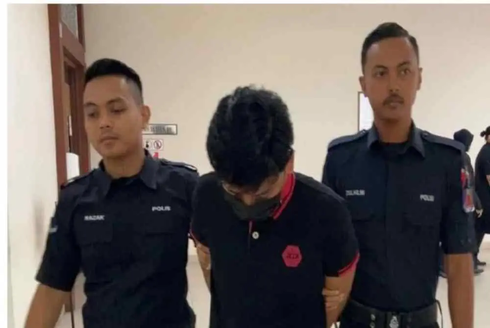 Muhammad Zuladha Ferhad Zuraini escorted by police