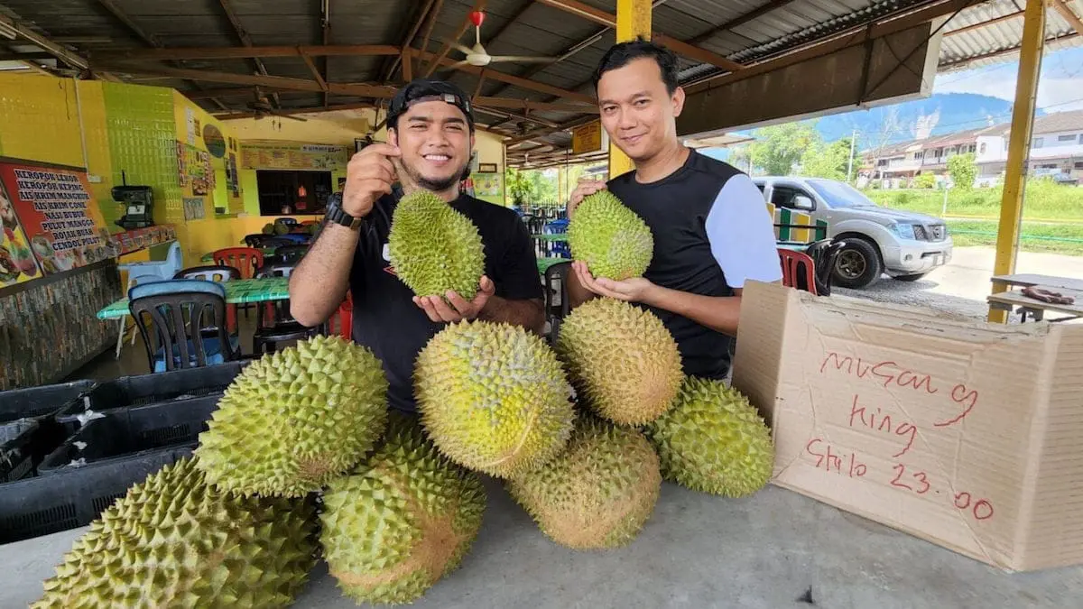 2 sellers holding durians