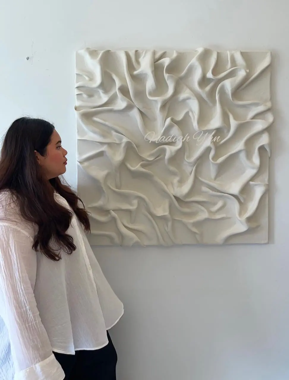 Nadiah Yan looking at a different abstract painting of hers