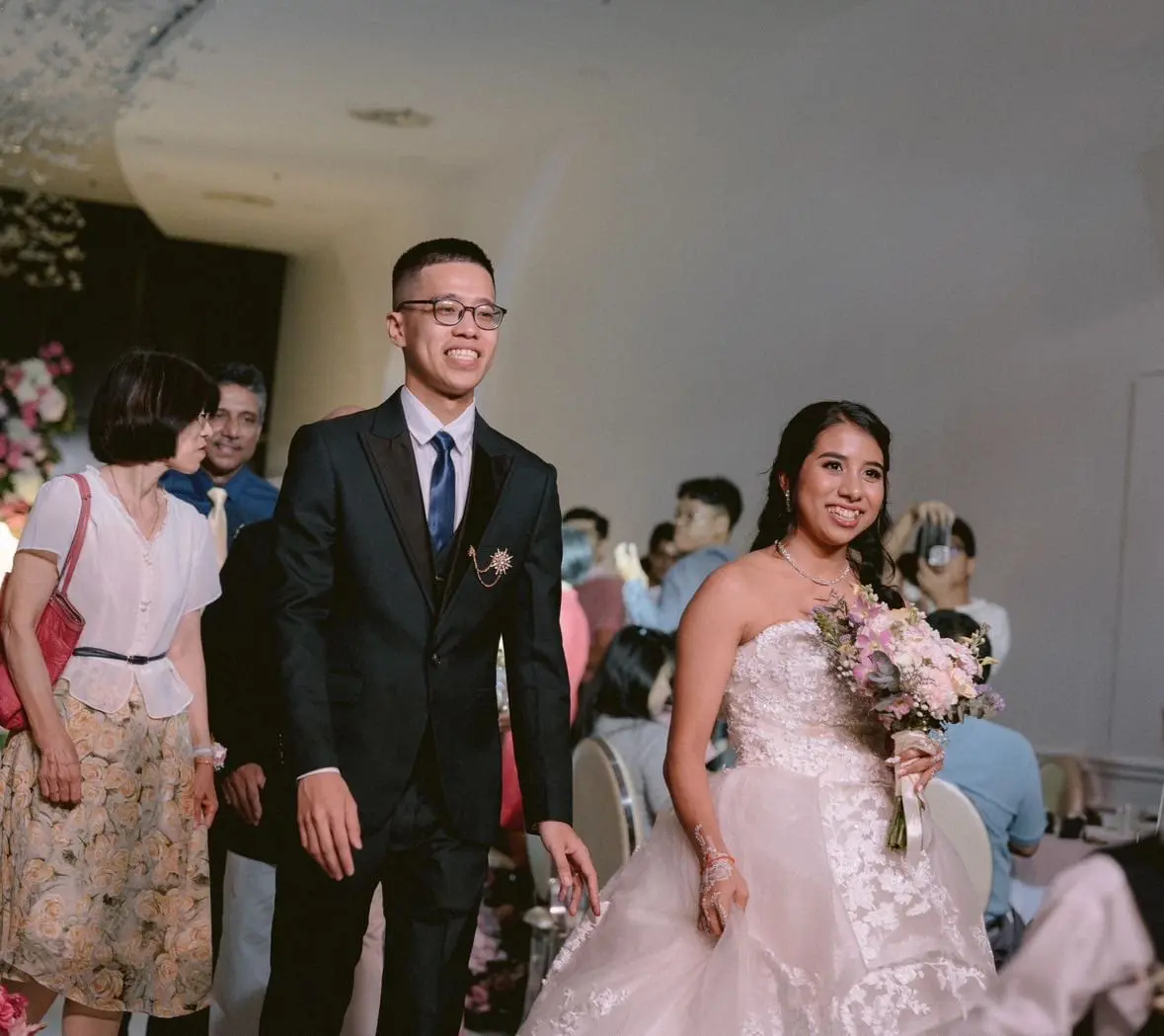 nicholas and narsheera walking at their wedding reception