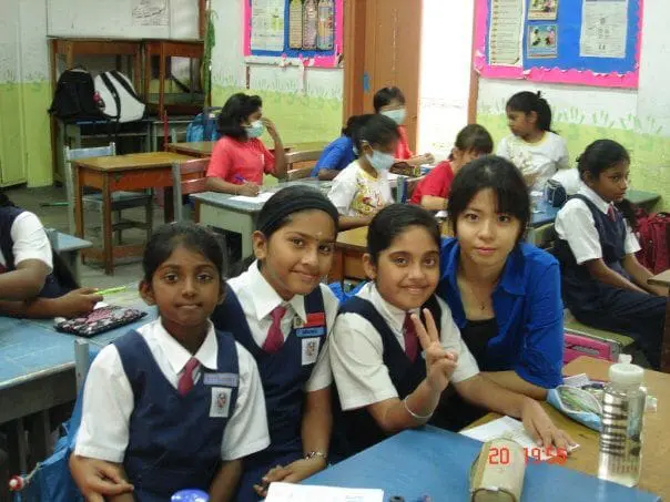 Nirosha in the primary school with her friends and teachers