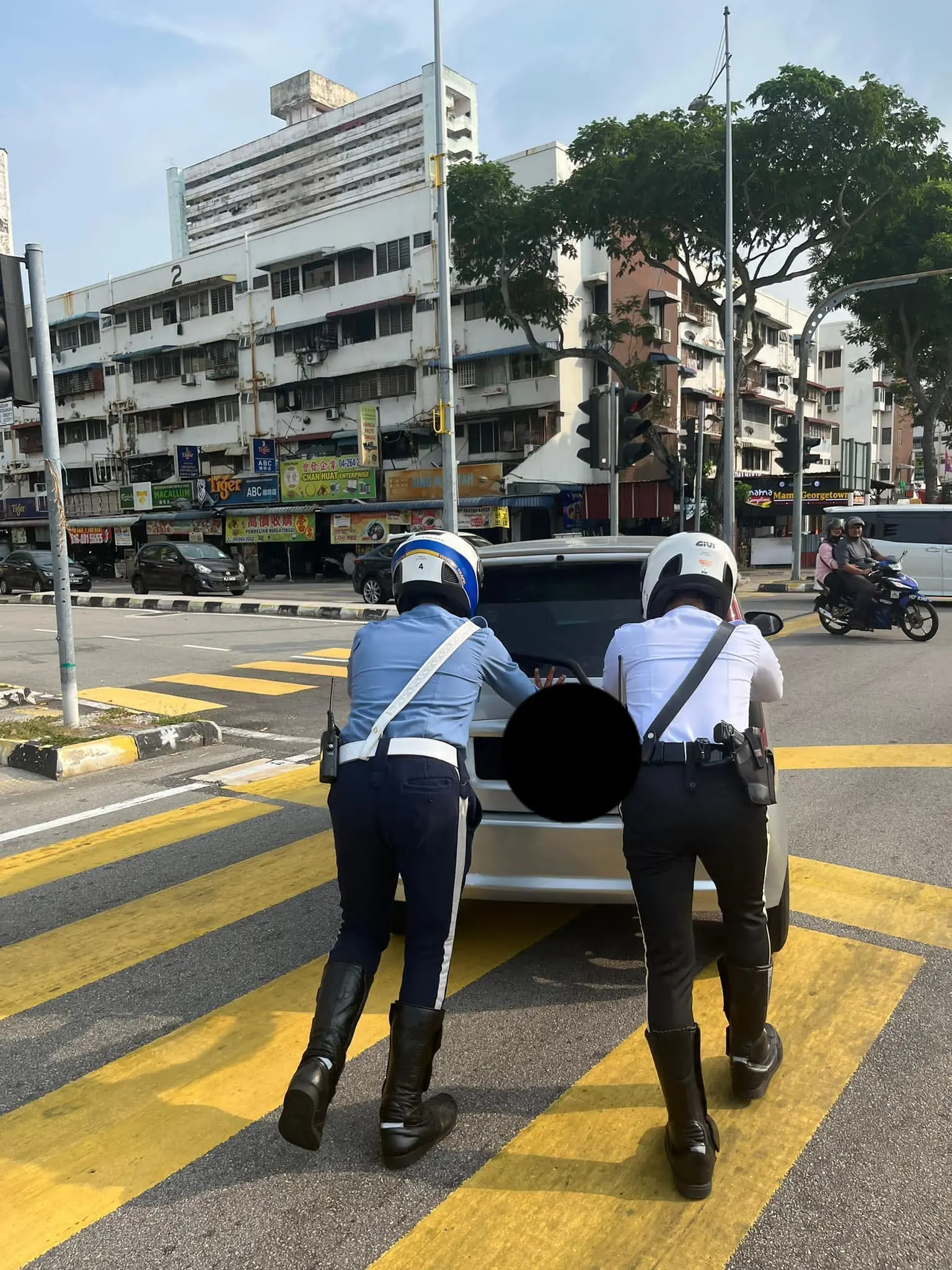 Officer moving the car off the road