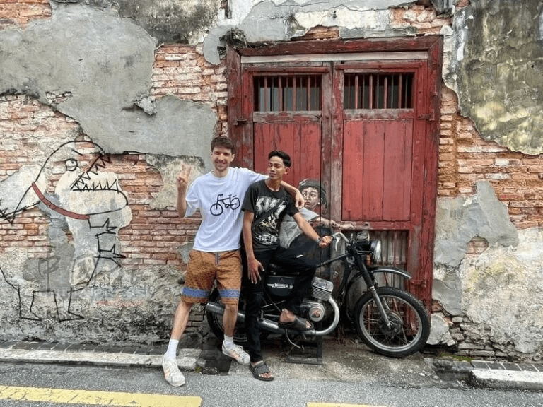 Person behind Boy on a Bike mural