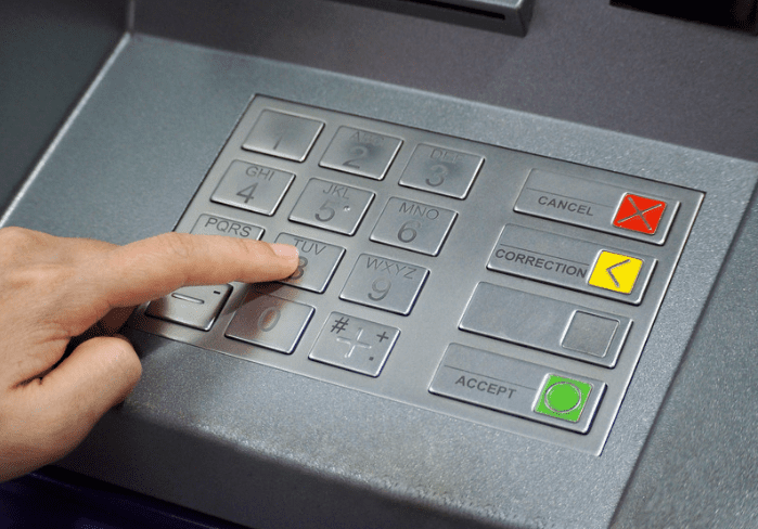 Person pressing ATM buttons