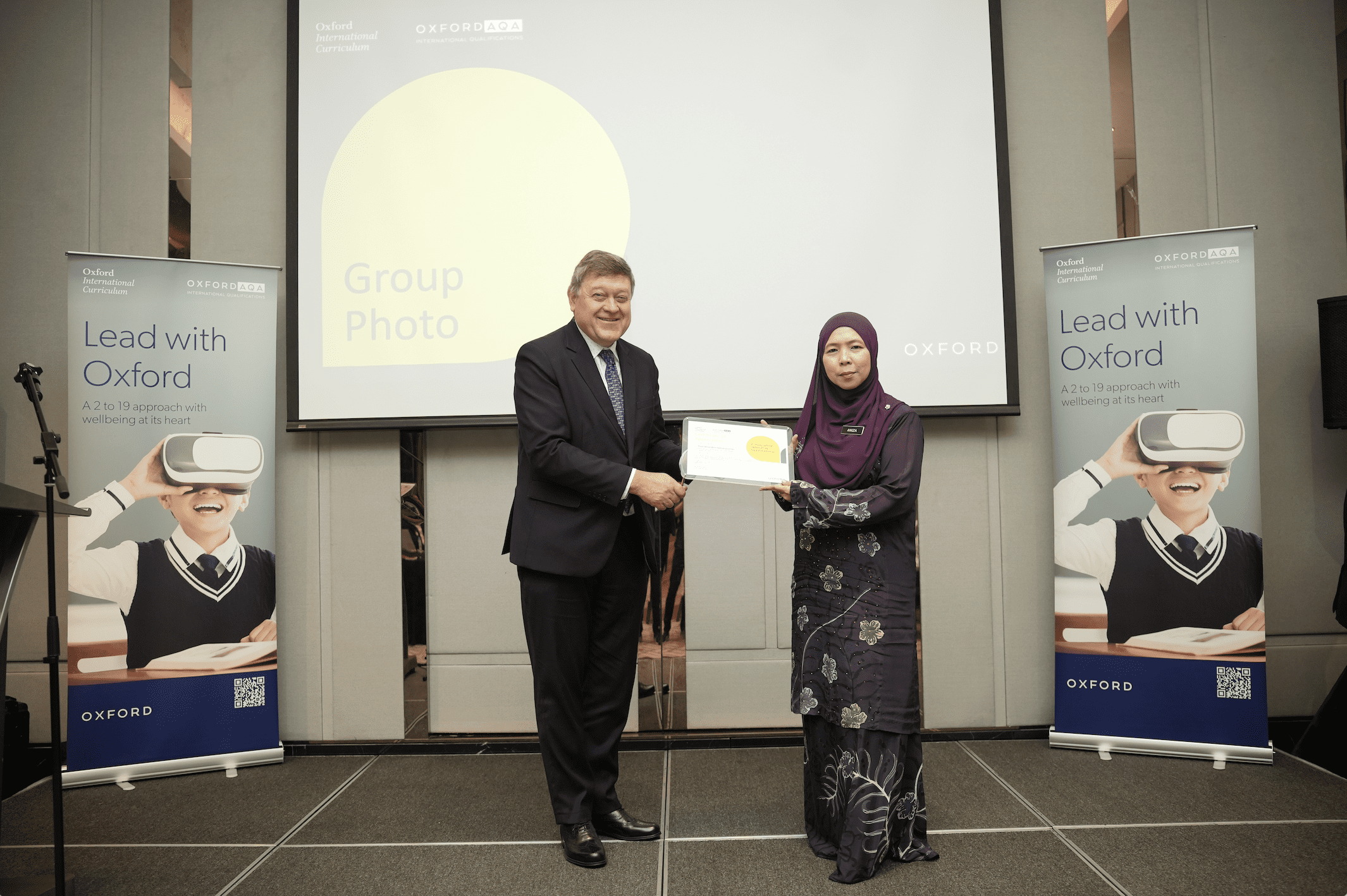 Andrew Coombe presenting a token of appreciation to Puan Aniza Kamarulzaman
