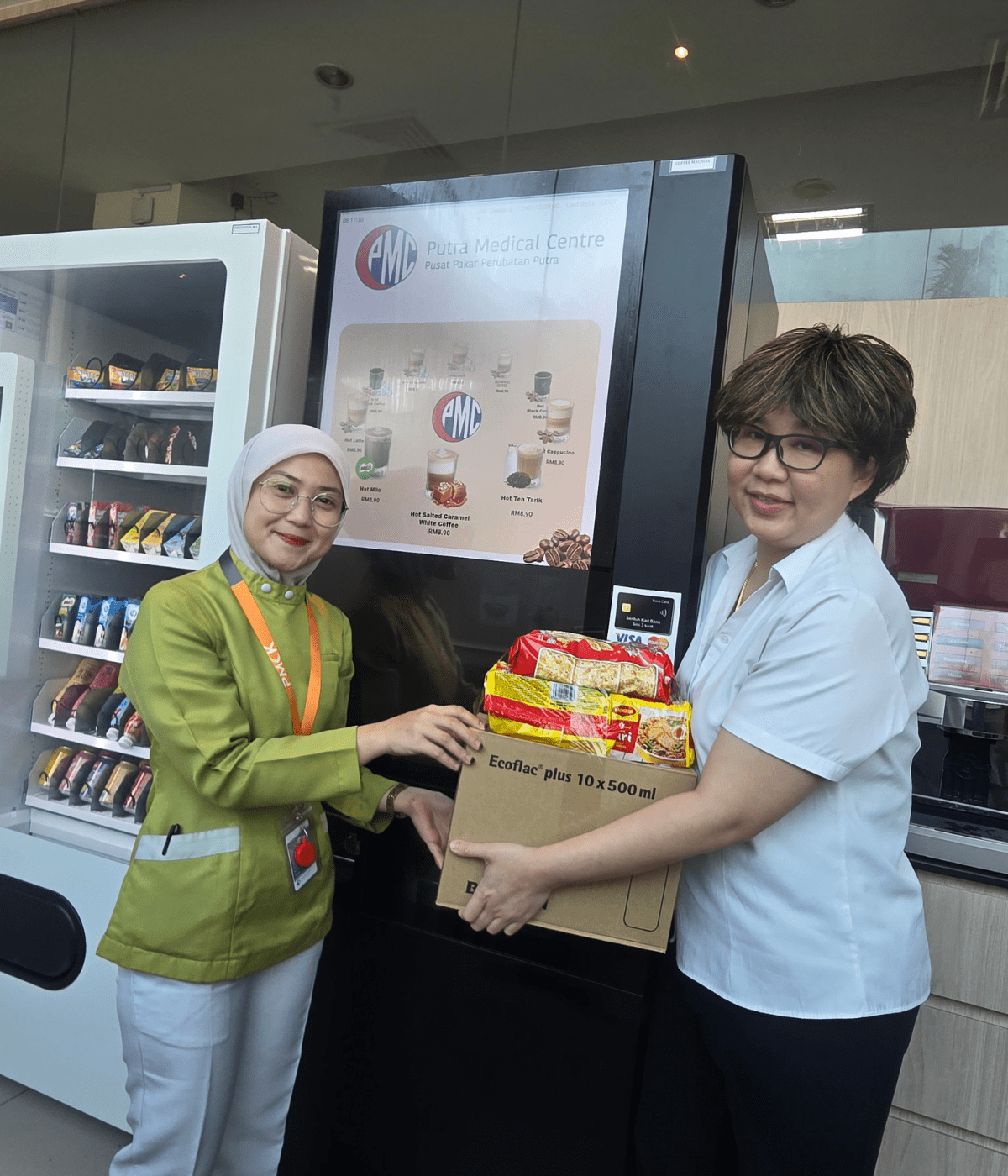 Photo 3 - PMC's Director of Allied Health Services, Lee Geik Peng, extends a care package to a non-clinical staff member as a show of solidarity.