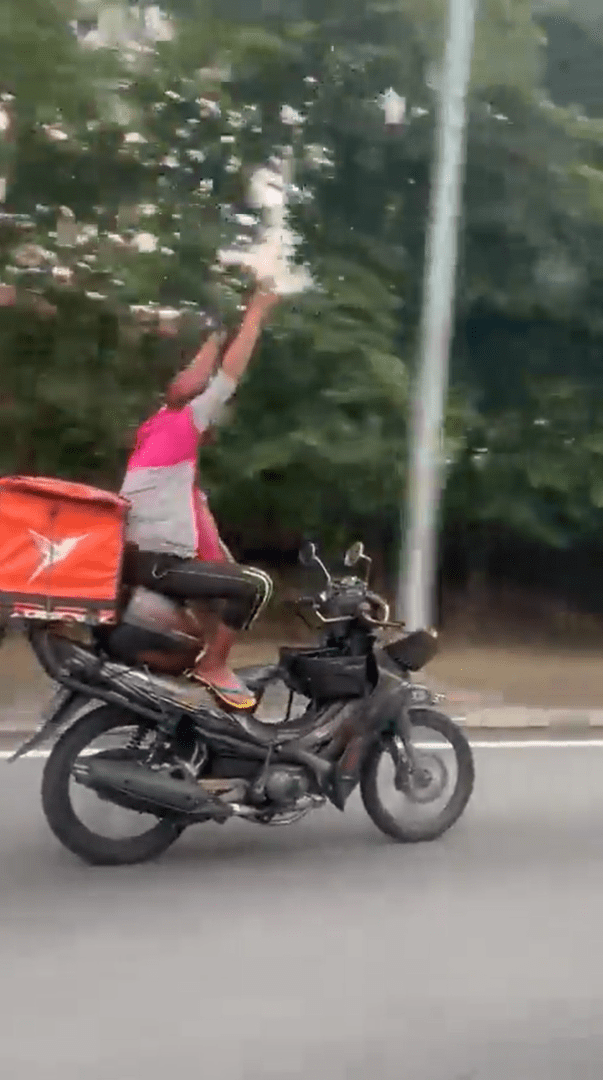 M'sian Delivery Rider Seen Riding Motorbike With No Hands, Nabbed By Police For Endangering Public Safety