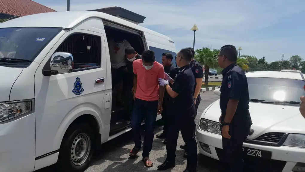 police bringing accused robbers out from a van to the court hearing