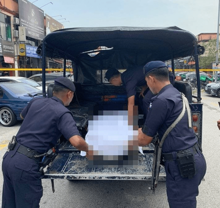 Police carry body of foreign man slashed to death