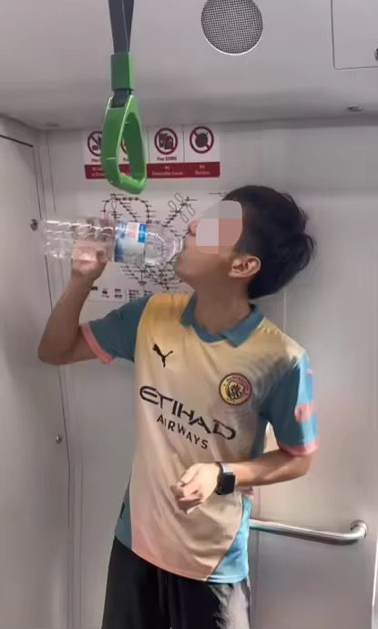 PRC man drinking water on the MRT