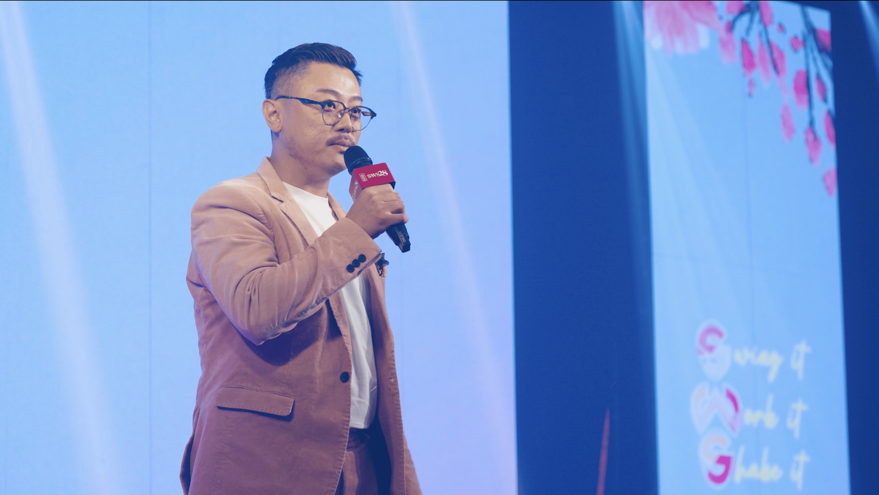 Project Manager of the MV & Chief Marketing Officer of SWS 28 - Alvin Khoo is giving speech