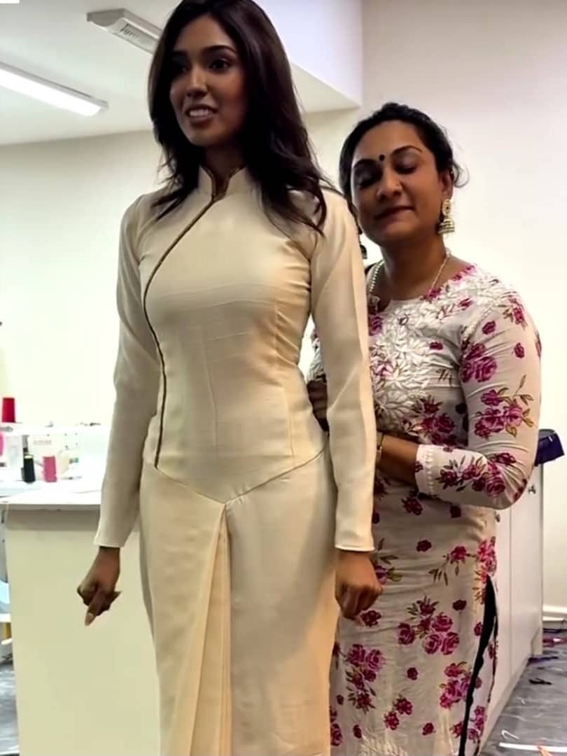 rekha and her client at her tailor shop