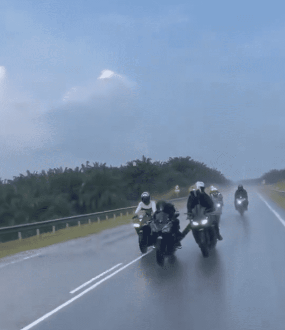 Riders escorting motorbike in rain (2)