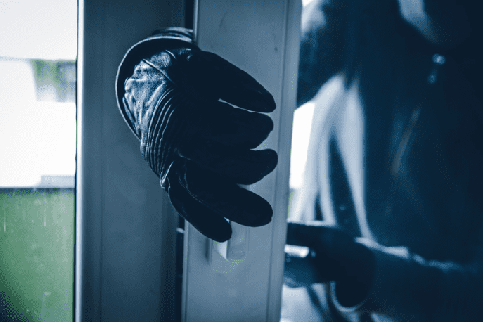 Robber breaking into a house