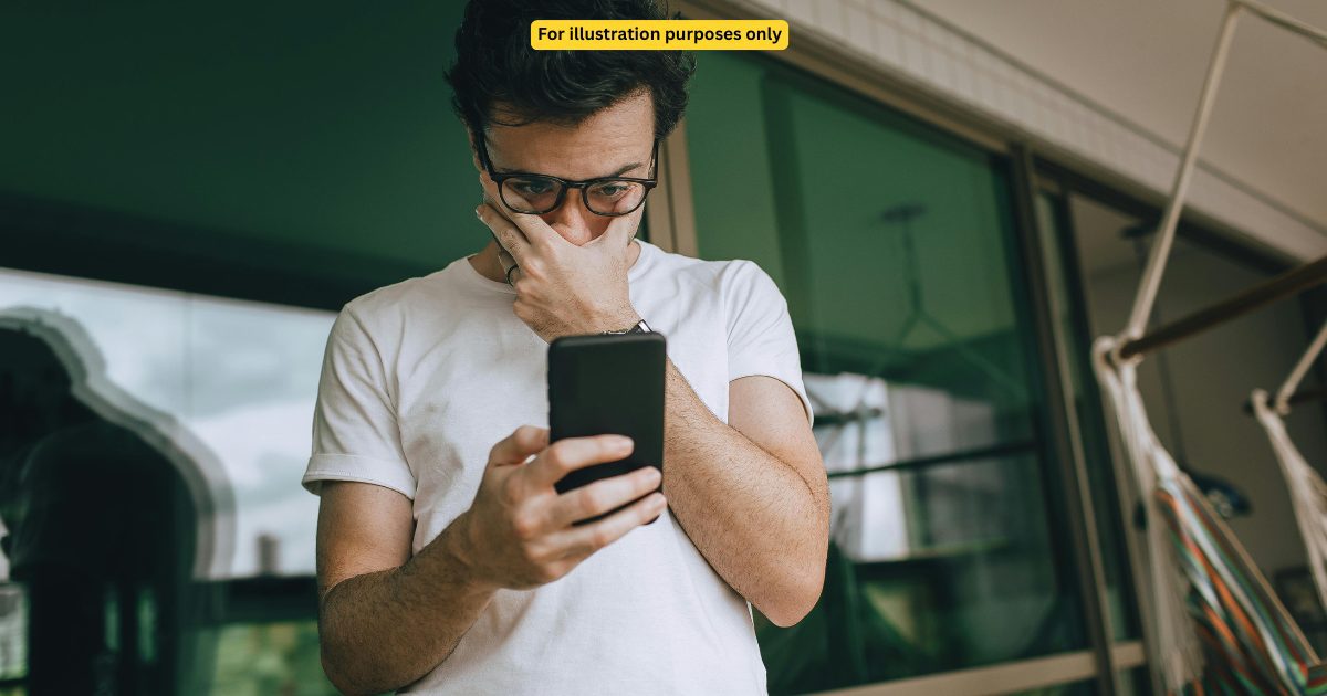 sad asian man looking at the phone